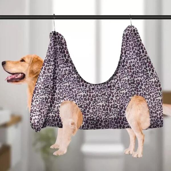 photo of a dog in a grooming hammock