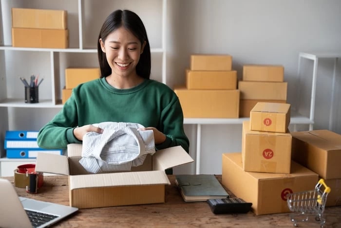 young-woman-packing-product-for-customer-with-card-2023-11-27-05-30-06-utc-min_jpg.jpg